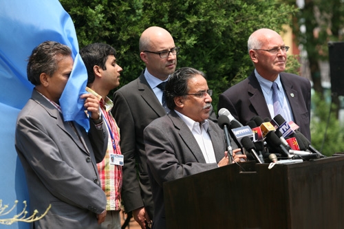 TRICK OF THE WIND: Maoist leader Pushpa Kamal Dahal (front), flanked by deputy Baburam Bhattarai (left, face in flag) and UNMIN chief Ian Martin (right), speaks at a press conference at UN House on Thursday morning.