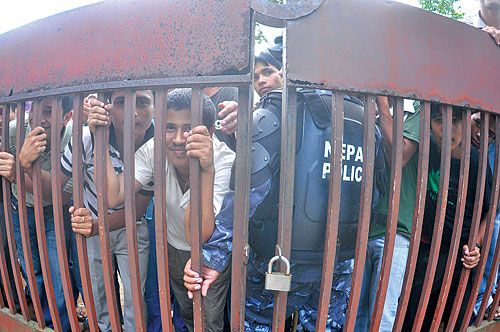 Iron gate: Students stand outside the Exam Controller's Office in Sano Thimi, Bhaktapur, on Monday, awaiting announcement of results of the SLC examination. This year, 55.5 per cent of the examinees were able to clear the examination.