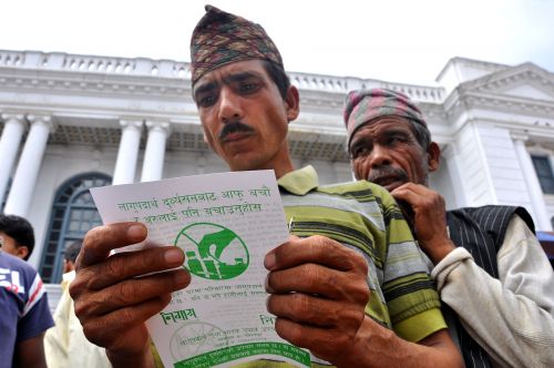 AWARENESS AT A GLANCE : Viewers look at the pamphlet distributed at a drug awareness program at Basantapur in Kathmandu June 26, 2011. According to the Central Bureau of Statistics, there are 46,309 drug users in Nepal in 2007 . The world marks the International Day against Drug Abuse and Illicit Trafficking on June 26.