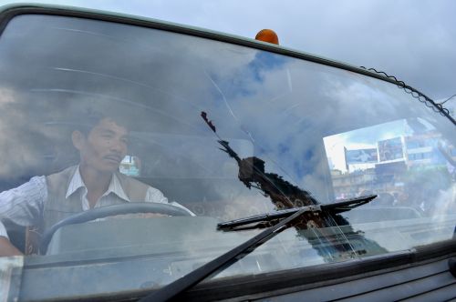 ONE MORE YEAR:Reflection of the chariot of Red Machhindranath is seen on the front glass of the Lalitpur metropolitan vehicle as it waits for the ceremony of Bhotojatra to conclude in Jawalakhel on Tuesday. A month long festival ends with the display of the vest of Red Machindranath.