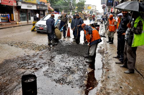 PATCH WORK: Workers from the Road Department repair roads at New Road, Kathmandu on Tuesday.
