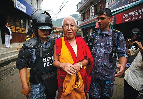 PARTY'S OVER: Police arrest a Tibetan monk on his way to celebrations of Dalai Lama's birthday at the Swayambhu premises on Wednesday. Authorities had enforced a ban on gatherings for the Tibetan spiritual leader's birth anniversary, fearing anti-China protests.