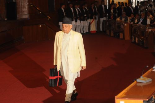 RED RIBBON: Finance Minister Bharat Mohan Adhikari heads towards the podium to present the budget for the fiscal year 2011/12. A budget of Rs 384.90 billion was presented.