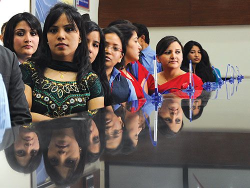 LET'S CUT THE CAKE: Employees of Mega Bank listen to their CEO, Anil Shah, make a speech at the Bank's first anniversary, celebrated at their head office in Kathmandu on Saturday.
