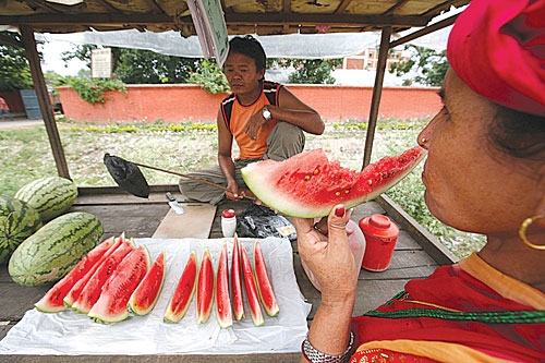 BODY COOLER: In contrast to Kathmandu, Chitwan temperatures were soaring on Wednesday. Here a woman cools down with a slice of watermelon.