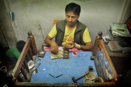 GOLD RUSH : A goldsmith shines an ornament in his workshop in in Kathmandu on Monday. The gold price sore to Rs 47,500.