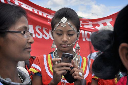 HI-FI ACCESSORY: A young Tharu woman at a cultural parade organised to celebrate the 17th International Indigenous Day, outside City Hall, Kathmandu, on Tuesday.