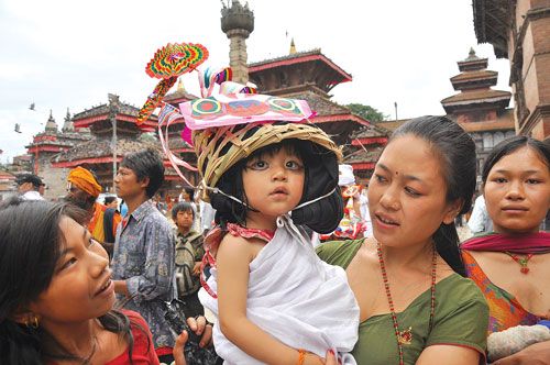 COSTUME CUSTOM: A child, dressed up as a cow, participates in a Gai Jatra procession at Basantapur Darbar Square on Sunday.