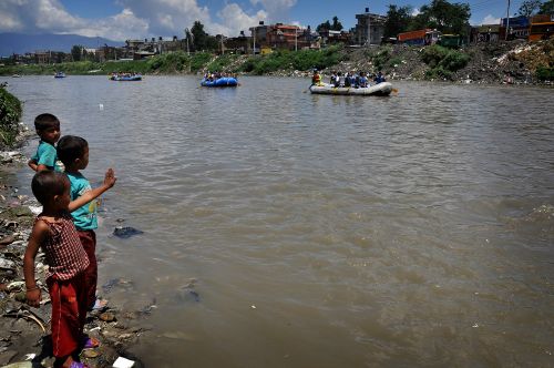 SAVE THE BAGMATI: Children watch as participants takes part while rafting at the Bagmati river to spread the message “Save Bagmati” on Saturday in Kathmandu.