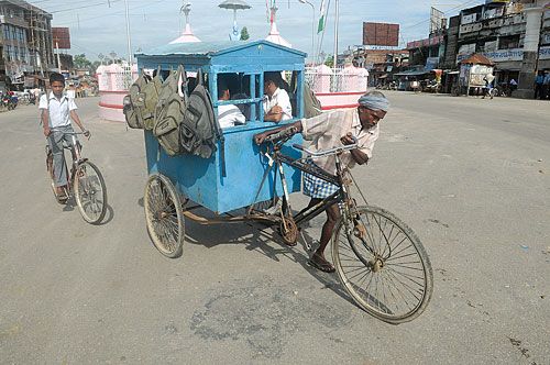 RIDE TO SCHOOL: Children being ferried to school on a tricycle in Lahan Bajar, Sunday