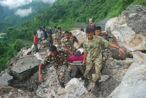 Security personnel carry an injured local to a safe area