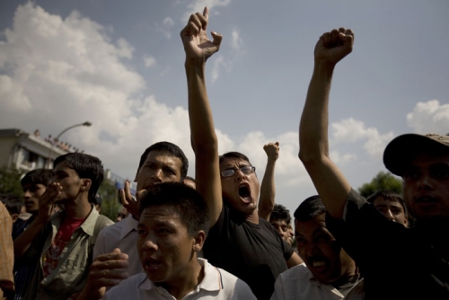 Protestors gather in hundreds outside the Narayanhiti Palace Thursday afternoon to demand that the King evacuate immediately.