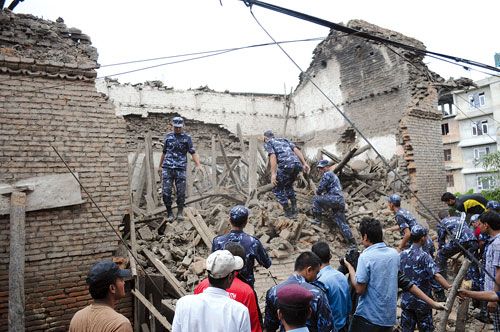 QUAKE EFFECT: Security personnel begin to clear the rubble of a house in Bhaktapur, that came down after Sunday's earthquake.