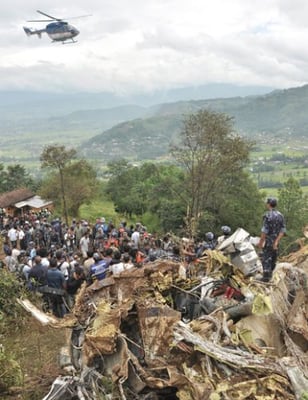 CRASH SITE: Rescue workers and civilians gather around the wreckage of Buddha Air's Beechcraft 1900D that crashed on Sunday morning at Bishankhunarayan, Lalitpur, on its way back to Kathmandu from a mountain flight. All 19 aboard were killed.