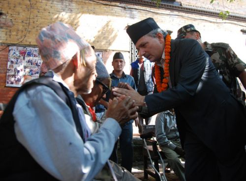 GOOD WISHES: Prime Minister Baburam Bhattarai at the Pashupati Old Age Home on Dashami, the tenth day of Dasain. Bhattarai distributed blankets and food at the home.