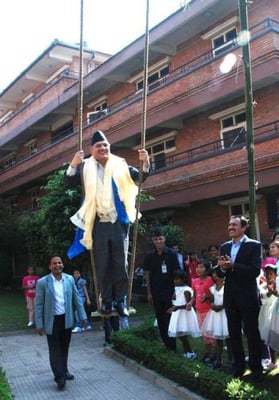 GOING WITH THE SWING: Prime Minister Baburam Bhattarai enjoys a swing at Maiti Nepal, during his visit on the occasion of Dasami, Thursday.