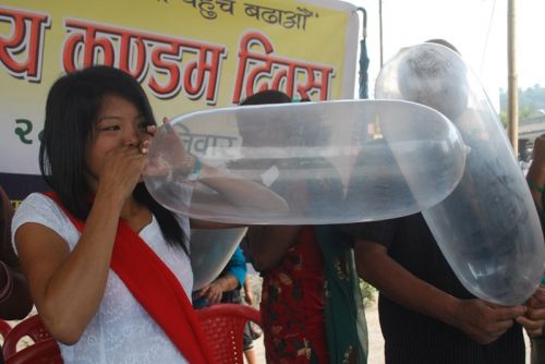 BLOW JOB: A youth activist in Dharan blows a condom balloon to spread awareness about HIV prevention and family planning in Dharan on Saturday on the ocassion of World Condom Day.