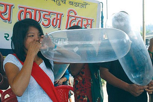 BLOW JOB: A youth activist in Dharan blows a condom baloon to spread awareness about HIV Prevention and family planning in Dharan on Saturday on the occasion of World Condom Day.