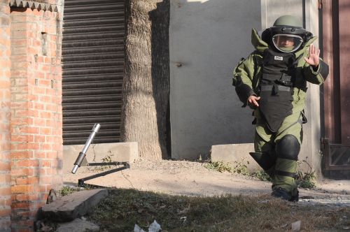 GEARED UP: A member of the bomb disposal team, Nepal Army, tries to difuse a suspected bomb in from of United Mission to Nepal's office, Thapathali on Tuesday. A low-intensity bomb had gone off earlier in the day, no one was hurt. Nepal Defense Army, a pro-hindu organisation, has claimed responsibility for the explosion.