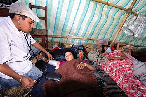 TAKE NOTICE: A doctor checks a Bhutanese woman on the ninth day of her hunger strike at the Bhutanese refugee camp in Beldagi II, Jhapa on Wednesday. Twelve women have been fasting unto death, demanding to be recognised as refugees.