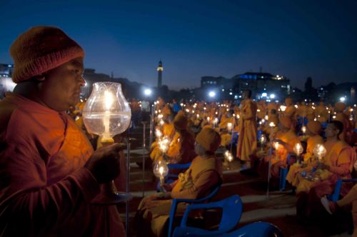 LIGHT FOR PEACE: A monk joins in a candle lighting program organised by International Dhammadayada Association, Nepal (IDAN) with the slogan 'Together for World Peace' at Tundikhel, Kathmandu, on Saturday evening.