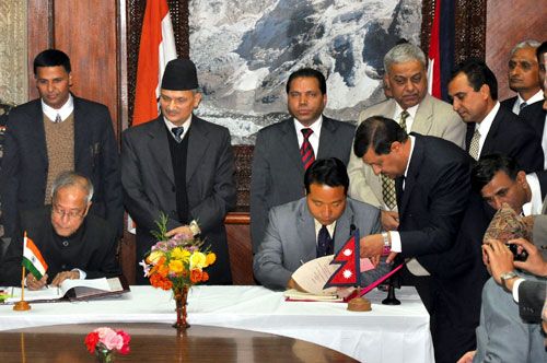 DOUBLE SIGN: PM Baburam Bhattrai looks on as the Indian Finance Minister Pranab Mukharjee and Finance Minister Barsa Man Pun sign the Double Taxation Avoidance Agreement (DTAA) at the PM's office, Singha Durbar on Sunday.