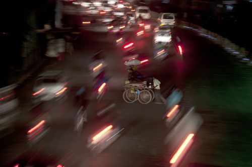 ON THE WAY HOME: A mobile food stall owner crosses the street in Ratnapark, Kathmandu, wrapping up the day's work on Monday evening.