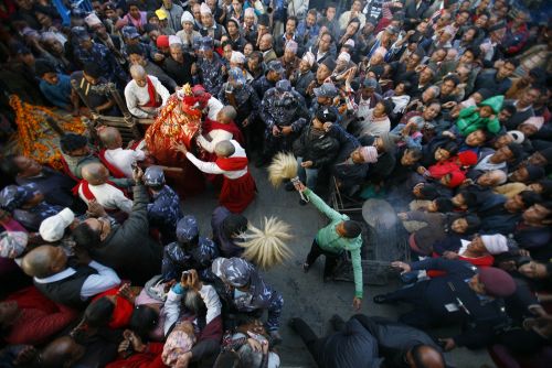 PAPARAZZI: Devotees surround the idol of Rato Machhindranath while priests carry the idol into a temple during a ritual in Lalitpur on Tuesday.