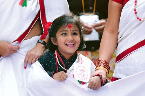 NEWAR DELIGHT: A girl at a rally celebrating the Newar festival, Yomari Purnima, in Thamel on Saturday. On this day, a special steamed delicacy of rice-flour filled with brown cane sugar and sesame seeds is prepared.
