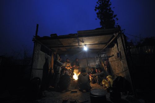 GLOOMY SUNDAY: Construction workers fight the cold with a bonfire outside Singa Darbar on Sunday.