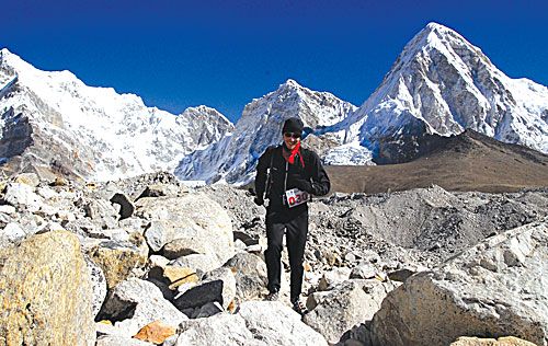 ROCKY ROAD: A competitor in the 6th Tenzing Hillary Everest Marathon scrambles over scree near the Everest Base Camp on 29 May.