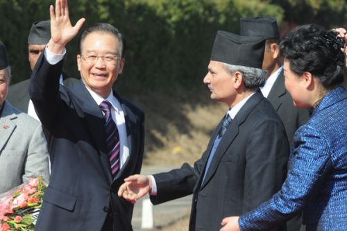 HI-FIVE: Prime Minister Baburam Bhattarai receives the Chinese Premier Wen Jibao at the TIA on Saturday for his five-hour visit to Nepal.