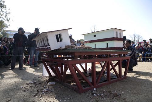 EARTHQUAKE ON STAGE: People watch as earthquake-resistant miniature house stands while a less seismic-proof one falls in a "shaking table" demo at Jawalakhel ground on Wednesday.