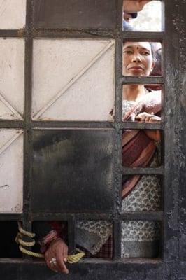 SMALL WINDOW: A landless squatter queues to register her identification on Sunday. An estimated 12,000 landless squatters live in Kathmandu with the majority living on the banks of Bagmati River.