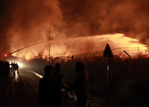 WILDFIRE KAYOS:Fire fighter spray water towards the wildfire caught at the grassland and bushes adjoining Tribhuvan International Airport (TIA) in Kathmandu on Tuesday.
