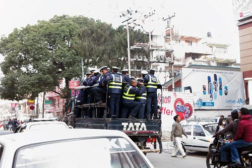 WHISTLE BLOWERS: Traffic police personnel traveling in a crammed pickup truck in Kathmandu on Monday.