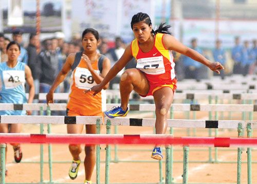 LEAPING HIGH: Winner of the 100m hurdle, female, Arati Pathak of Nepal Police Club, jumps to the finish line during the sixth National Games in Dhangadi on Wednesday