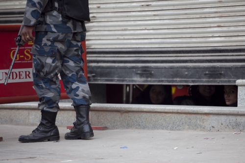 FALSE ALARM: A security personnel stands gaurd outside a closed shop in Baneshwor as a bomb disposal squad from the Nepal Army set to work defusing a suspected bomb on Sunday. However, the incident turned out to be a hoax.