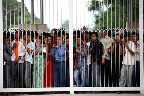 THE LONG WAIT: Hundreds of people throng the gates of the palace, and only journalists were allowed in for the press conference on Wednesday afternoon.