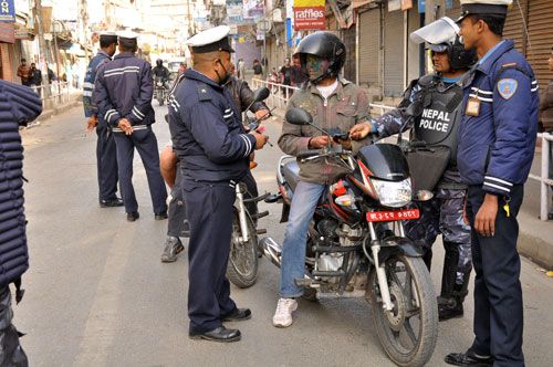 SNIFF SNIFF: Traffic police check a motorcycle rider for alcohol consumption on Wednesday afternoon to curb accidents caused by drunk driving during Holi. Over 50 motorcyclists were caught in Kathmandu.