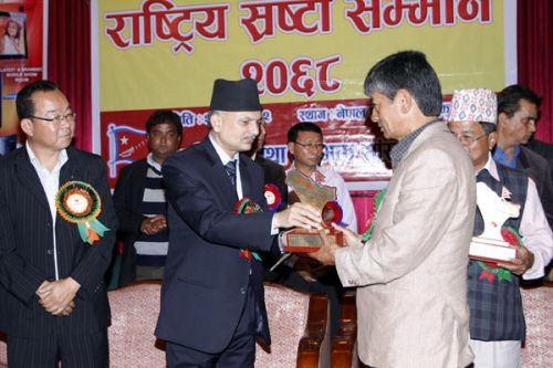 ARTIST APPRECIATION: PM Babauram Bhattarai honours actor Madan Krishna Shrestha at a program in Nepal Tourism Board on Sunday, organised by Progressive and Nationalistic Cultural Front. J B Tuhure, Hari Bansha Acharya, Ram Krishna Dhakal, Krishna Hari Baral, Kunti Moktan were other artists that recieved honours.