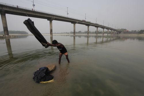 MORNING WASH: A washerman washes clothes in Narayani River, Narayanghat, on Monday morning.