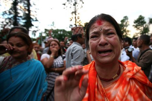 LAST GOODBYE: Supporters of the monarchy weep in front of the palace gates on Wednesday afternoon.