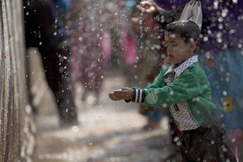 HOLY WASH: A boy washes his hands at the Balaju Baise Dhara, Balaju, Kathmandu, during Baishak Asnan festival on Friday.