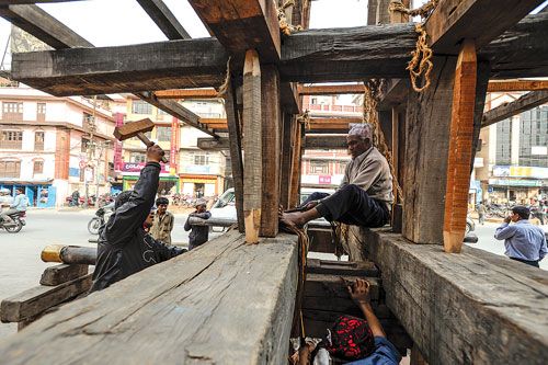 HEAVENLY ABODE: Locals securing the ropes around the base of the Rato Macchendra Nath chariot along Pulchok on Tuesday.