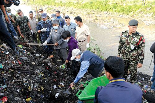 FAMILY AFFAIR: PM Baburam Bhattarai, daughter Manushi and wife Hisila Yami (left to right) join the cleaning campaign on the banks of the Bagmati on Thursday morning.