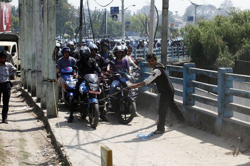 READY, GET SET, GO: Motorcyclists are finally allowed to fill up their tanks, after waiting in que for several hours infront of the Army gas station at Bhadrakali.