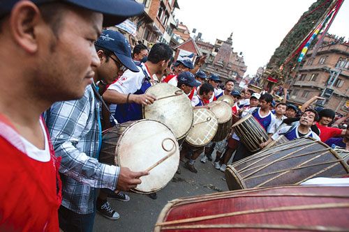 BEAT THE DRUMS: Locals play traditional drums to celebrate the arrival of the Rato Macchendra Nath chariot in Lagankhel on Friday.