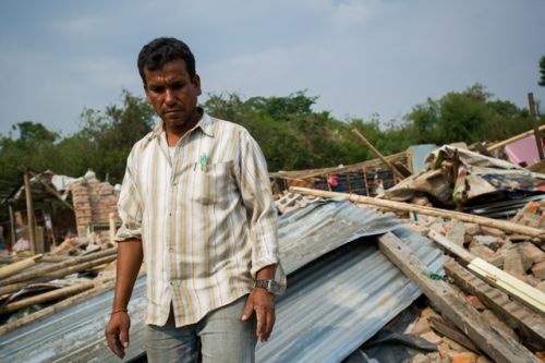 BROKEN HOMES: Rajesh, 42, walks down a pile of rubble which used to be his home along the Bagmati river at Thapathali. On early Tuesday morning the Armed Police Force and bulldozers rolled in to demolish houses and and evict squatters. Ten people were detained for resisting eviction and teargas was fired into the premises to clear out the residents.