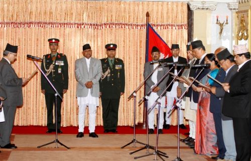 ONCE MORE: PM Baburam Bhattarai administers the oath of office and secrecy to seven new ministers, including those of the UML on Wednesday at Shital Niwas, the President's office.